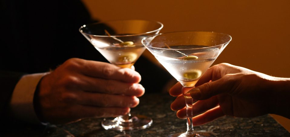 Two martinis raised in a toast